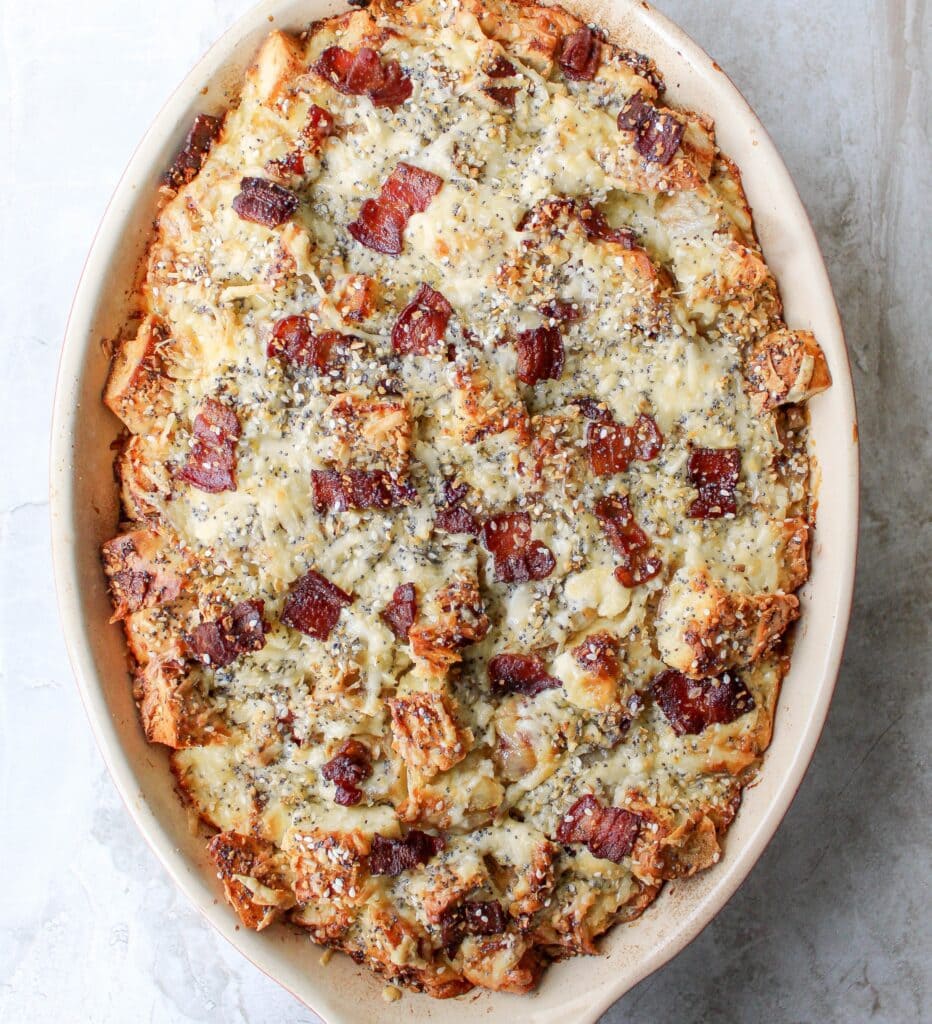 breakfast-bagel-casserole-932x1024-1 Breakfast sandwich strata made with bagels, crispy bacon, and cheese in a custardy casserole.