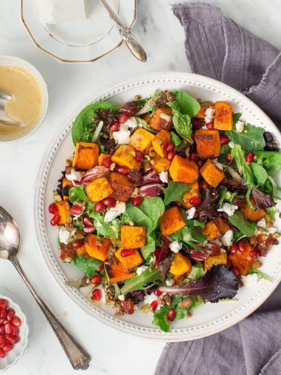 butternut-squash-salad Roasted butternut squash salad with spiced squash, juicy pomegranate seeds, and tangy goat cheese.