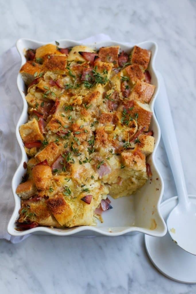 croque-monsieur-savory-bread-pudding Croque monsieur savory bread pudding on a white baking dish.