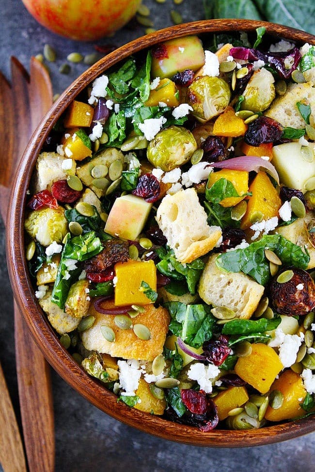 fall-panzanella-salad Fall panzanella salad in a wooden bowl with butternut squash, Brussels sprouts, apple, dried cranberries, pepitas, goat cheese, and kale.
