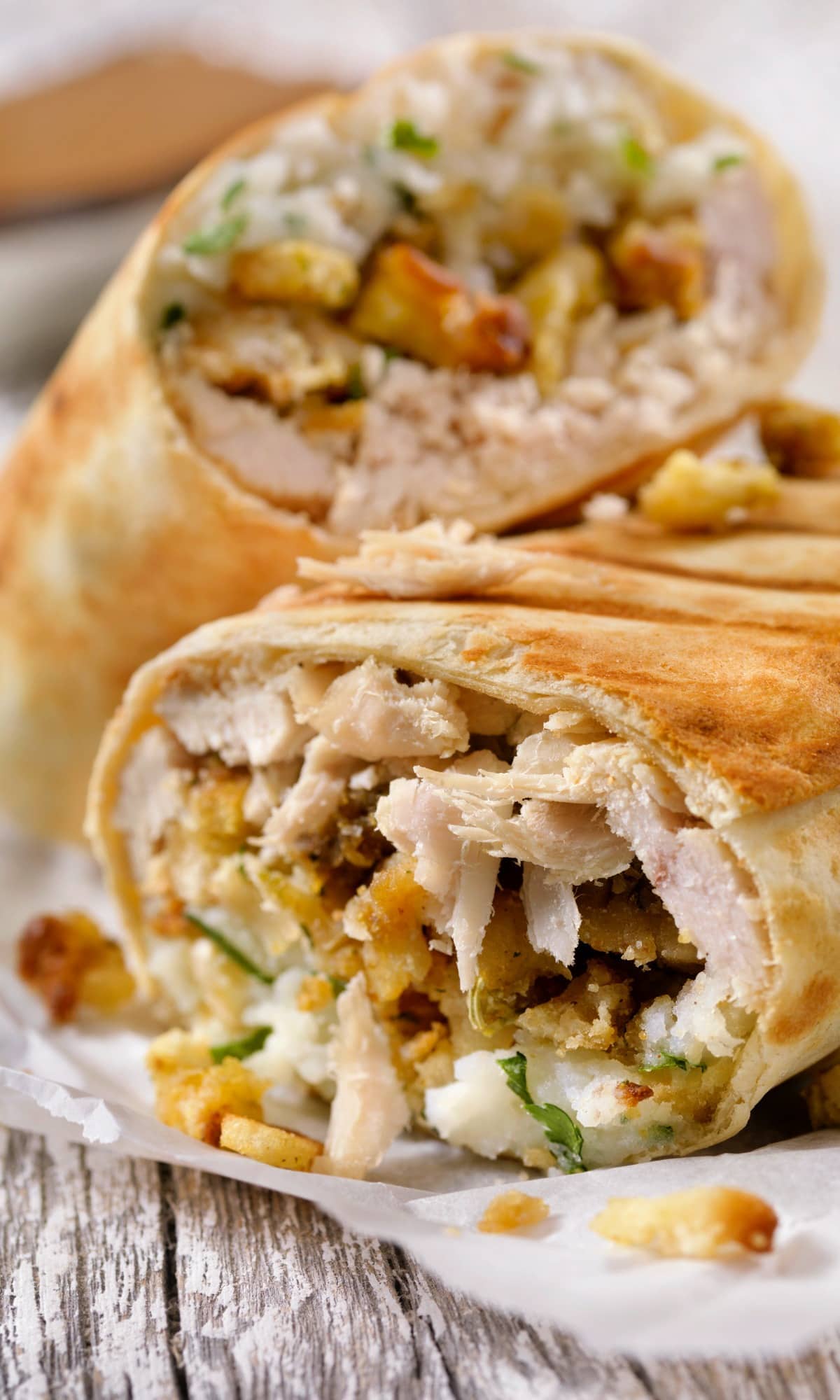 Burritos with turkey, sliced avocado, salsa, and cheese filling.