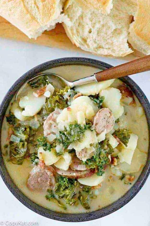 olive-garden-zuppa-toscana Top view of a serving of Garden Zuppa Toscana in a black bowl.