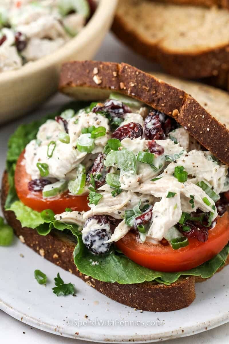 Sandwich with pecans, turkey meat, lettuce and cranberry filling.