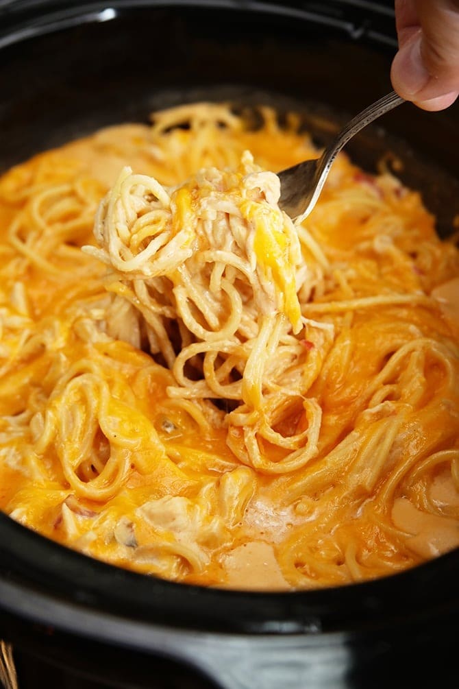 Fork scooping on a creamy Crockpot Chicken Spaghetti